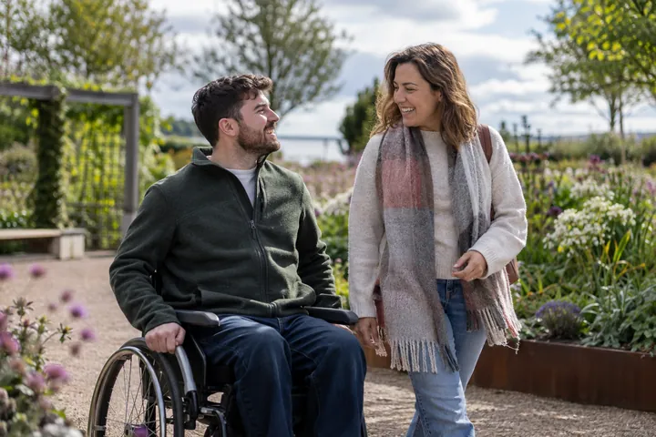 Two adults talking in an accessible garden